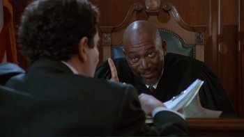 Movie still from “The Bonfire of the Vanities” (1990), directed by Brian De Palma – A man in a black robe is looking in the mirror; Medium shot, Low angle