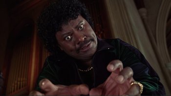 Movie still from “The Bonfire of the Vanities” (1990), directed by Brian De Palma – A person wearing a black shirt; Close Up shot, Low angle