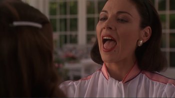 Movie still from “The Bonfire of the Vanities” (1990), directed by Brian De Palma – A person with her mouth wide open; Close Up shot, Over the shoulder angle