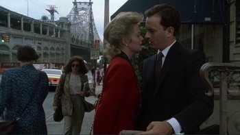 Movie still from “The Bonfire of the Vanities” (1990), directed by Brian De Palma – A man and a woman are talking to each other on the sidewalk; Medium shot, Low angle