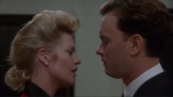 Movie still from “The Bonfire of the Vanities” (1990), directed by Brian De Palma – A man and a woman face to face in front of a mirror; Close Up shot, Low angle