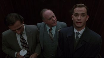 Movie still from “The Bonfire of the Vanities” (1990), directed by Brian De Palma – A group of men standing next to each other in suits; Medium shot, Low angle