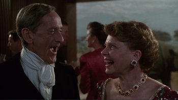 Movie still from “The Bonfire of the Vanities” (1990), directed by Brian De Palma – A man and a woman laughing together at a party; Close Up shot, Low angle