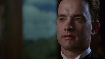 Movie still from “The Bonfire of the Vanities” (1990), directed by Brian De Palma – A person wearing a suit and tie; Close Up shot, Low angle