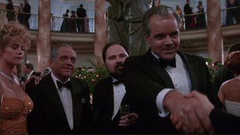 Movie still from “The Bonfire of the Vanities” (1990), directed by Brian De Palma – A group of men in tuxedos standing next to each other; Medium shot, Low angle