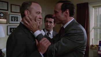 Movie still from “The Bonfire of the Vanities” (1990), directed by Brian De Palma – A couple of men standing next to each other; Close Up shot, Over the shoulder angle