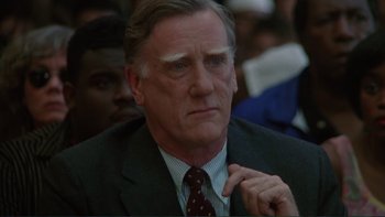 Movie still from “The Bonfire of the Vanities” (1990), directed by Brian De Palma – An older man in a suit and tie looking to his left; Close Up shot, Low angle