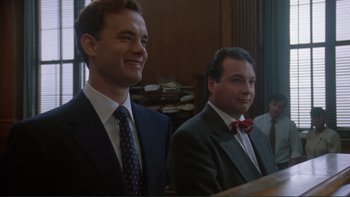 Movie still from “The Bonfire of the Vanities” (1990), directed by Brian De Palma – A couple of men standing next to each other in a room; Medium shot, Low angle