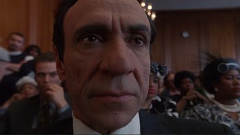 Movie still from “The Bonfire of the Vanities” (1990), directed by Brian De Palma – A man's face in a crowd; Close Up shot, Low angle