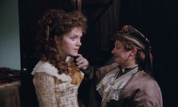 Movie still from “The Bostonians” (1984), directed by James Ivory – An older woman putting a bow on a young woman's neck; Close Up shot, Over the shoulder angle