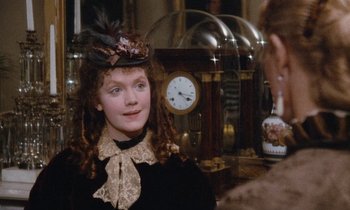 Movie still from “The Bostonians” (1984), directed by James Ivory – A young woman wearing a hat and a dress; Close Up shot, Over the shoulder angle