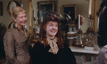 Movie still from “The Bostonians” (1984), directed by James Ivory – A woman and a woman standing in front of a mirror; Medium shot, High angle