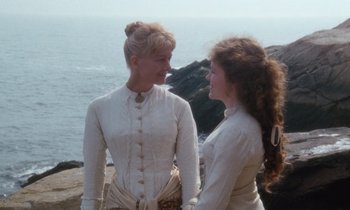 Movie still from “The Bostonians” (1984), directed by James Ivory – Two women standing next to each other near the ocean; Medium shot, High angle