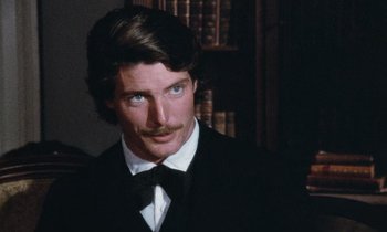 Movie still from “The Bostonians” (1984), directed by James Ivory – A person wearing a suit and tie; Close Up shot, Over the shoulder angle
