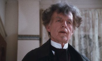 Movie still from “The Bostonians” (1984), directed by James Ivory – An older man in a black suit and white tie; Close Up shot, Low angle