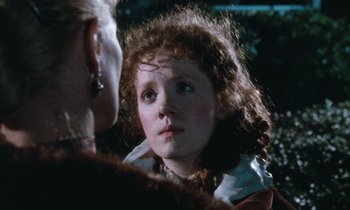 Movie still from “The Bostonians” (1984), directed by James Ivory – A young girl looking into a mirror in front of another woman; Close Up shot, Over the shoulder angle