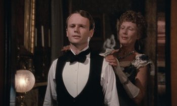 Movie still from “The Bostonians” (1984), directed by James Ivory – An older woman putting money on a young man's neck; Close Up shot, Over the shoulder angle