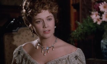 Movie still from “The Bostonians” (1984), directed by James Ivory – A person wearing a necklace; Close Up shot, Over the shoulder angle