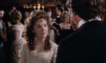 Movie still from “The Bostonians” (1984), directed by James Ivory – A man and a woman in formal wear standing in a crowd; Close Up shot, Over the shoulder angle
