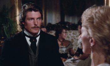 Movie still from “The Bostonians” (1984), directed by James Ivory – A man in a suit and tie in front of two women; Close Up shot, Over the shoulder angle