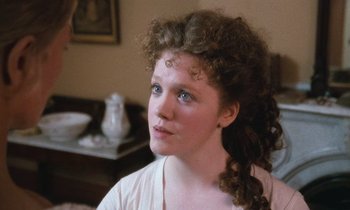 Movie still from “The Bostonians” (1984), directed by James Ivory – A young woman with blue eyes looking to her left; Close Up shot, Over the shoulder angle