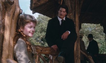 Movie still from “The Bostonians” (1984), directed by James Ivory – A man and a woman standing next to each other on top of a wooden structure; Medium shot, Low angle