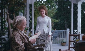 Movie still from “The Bostonians” (1984), directed by James Ivory – Two women on a porch , one of whom is reading a letter; Medium shot, Over the shoulder angle