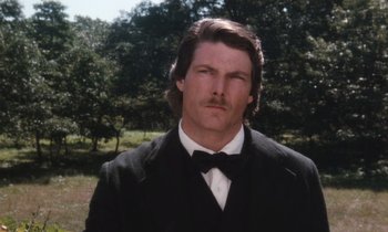 Movie still from “The Bostonians” (1984), directed by James Ivory – A person wearing a suit and bow tie; Close Up shot, Low angle