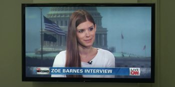 Movie still from “House of Cards” (2013), created by Beau Willimon – A woman is sitting in front of a television; Medium shot, Over the shoulder angle