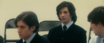 Movie still from “The Box” (2009), directed by Richard Kelly – A man in a suit and tie sitting next to another man in a suit and tie; Close Up shot, Over the shoulder angle