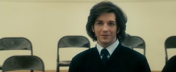 Movie still from “The Box” (2009), directed by Richard Kelly – A man with long hair wearing a suit and tie; Close Up shot, Over the shoulder angle