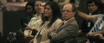 Movie still from “The Box” (2009), directed by Richard Kelly – A group of people sitting next to each other in a room; Medium shot, Over the shoulder angle