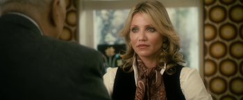 Movie still from “The Box” (2009), directed by Richard Kelly – A person sitting in a room; Close Up shot, Over the shoulder angle