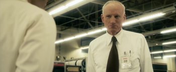 Movie still from “The Box” (2009), directed by Richard Kelly – An older man wearing a white shirt and a tie; Close Up shot, Low angle