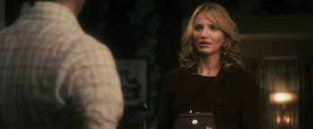 Movie still from “The Box” (2009), directed by Richard Kelly – A woman standing next to a man in front of a mirror; Close Up shot, Over the shoulder angle