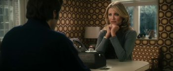 Movie still from “The Box” (2009), directed by Richard Kelly – A woman sitting in front of a man in front of a mirror; Medium shot, Over the shoulder angle