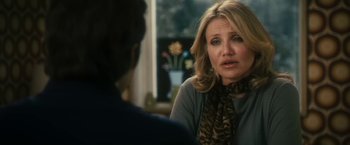 Movie still from “The Box” (2009), directed by Richard Kelly – A woman sitting in front of a man in front of a window; Close Up shot, Over the shoulder angle