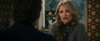 Movie still from “The Box” (2009), directed by Richard Kelly – A woman sitting in front of a man in front of a window; Close Up shot, Over the shoulder angle