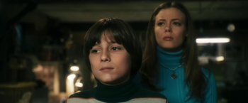 Movie still from “The Box” (2009), directed by Richard Kelly – A woman and a boy standing next to each other; Medium shot, Low angle