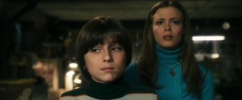 Movie still from “The Box” (2009), directed by Richard Kelly – A woman and a boy standing next to each other; Close Up shot, Low angle