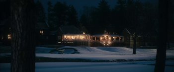 Movie still from “The Box” (2009), directed by Richard Kelly – A house in the snow at night with lights on; Extreme Wide shot, High angle