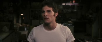 Movie still from “The Box” (2009), directed by Richard Kelly – A person wearing a white t - shirt; Close Up shot, Over the shoulder angle