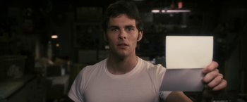 Movie still from “The Box” (2009), directed by Richard Kelly – A person wearing a white t - shirt; Close Up shot, Low angle