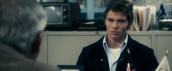 Movie still from “The Box” (2009), directed by Richard Kelly – A man in a black jacket is looking at the camera; Close Up shot, Over the shoulder angle