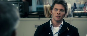 Movie still from “The Box” (2009), directed by Richard Kelly – A person wearing a suit and tie; Close Up shot, Over the shoulder angle