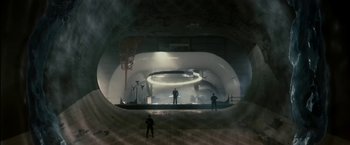 Movie still from “The Box” (2009), directed by Richard Kelly – Two men standing inside a large pipe in an industrial setting; Extreme Wide shot, High angle