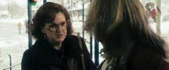 Movie still from “The Box” (2009), directed by Richard Kelly – A woman wearing glasses talking to another woman; Close Up shot, Over the shoulder angle
