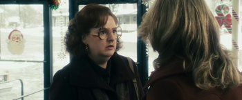 Movie still from “The Box” (2009), directed by Richard Kelly – A woman wearing glasses talking to another woman; Close Up shot, Over the shoulder angle