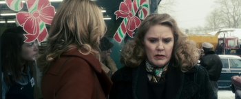 Movie still from “The Box” (2009), directed by Richard Kelly – Two women are standing next to each other on a train; Close Up shot, Over the shoulder angle