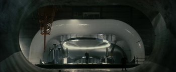 Movie still from “The Box” (2009), directed by Richard Kelly – A man standing on a staircase inside a building; Extreme Wide shot, Low angle